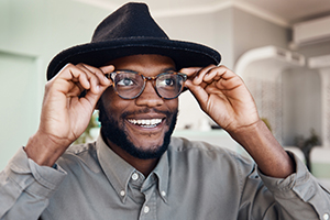 Male trying on a new pair of eyeglasses.