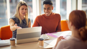 woman and intern working together at computer