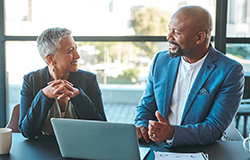 A woman planning for her retirement years meets with her financial professional to discuss converting an IRA to a Roth IRA.