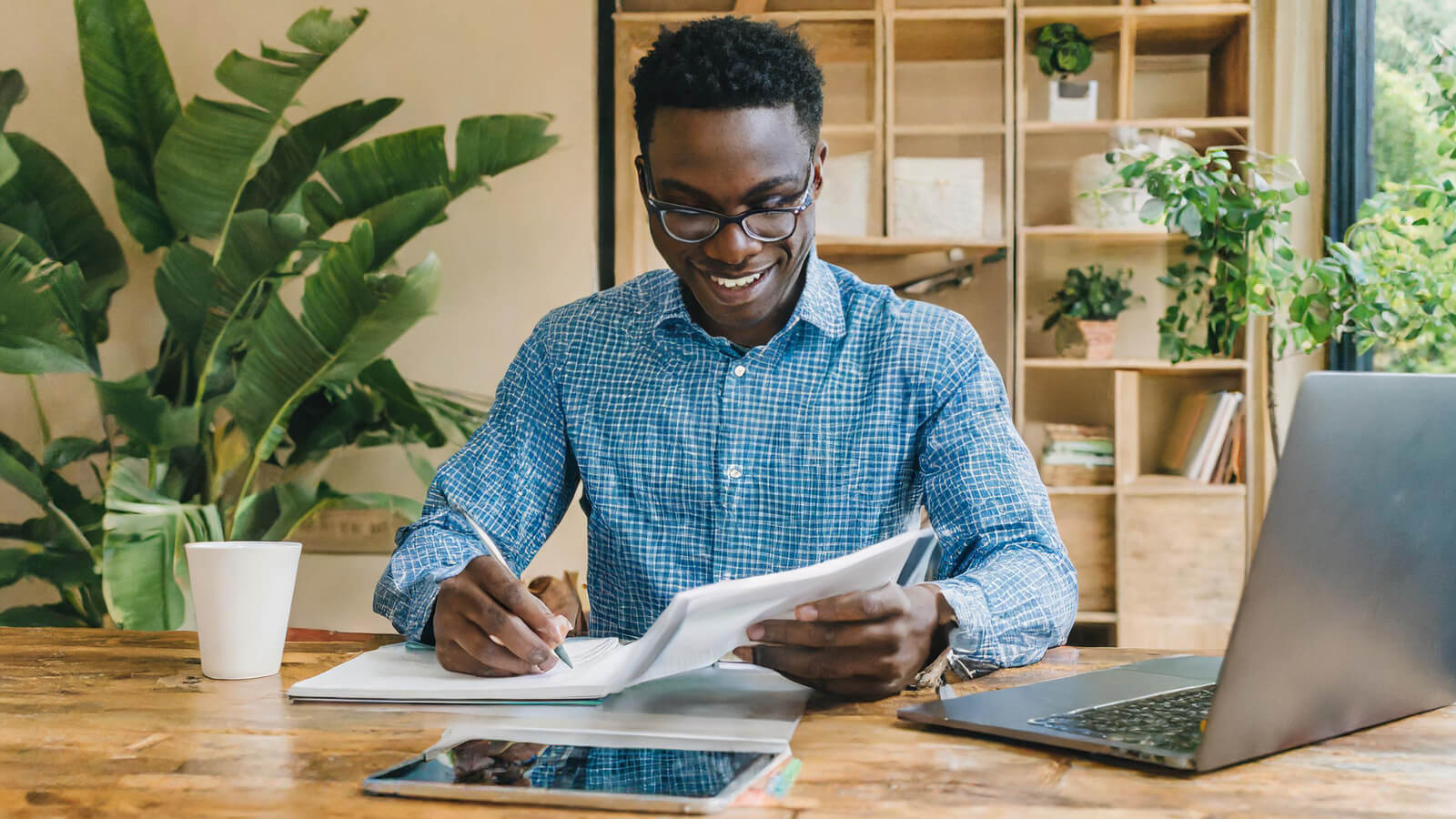 A young man reviews his spending habits and receipts as he learns how to make a budget to improve his financial well-being.