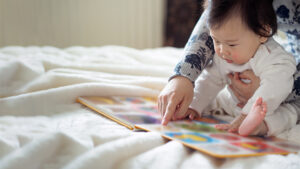Parent and child looking at a book together.