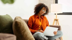 Smiling attractive African American woman using laptop.