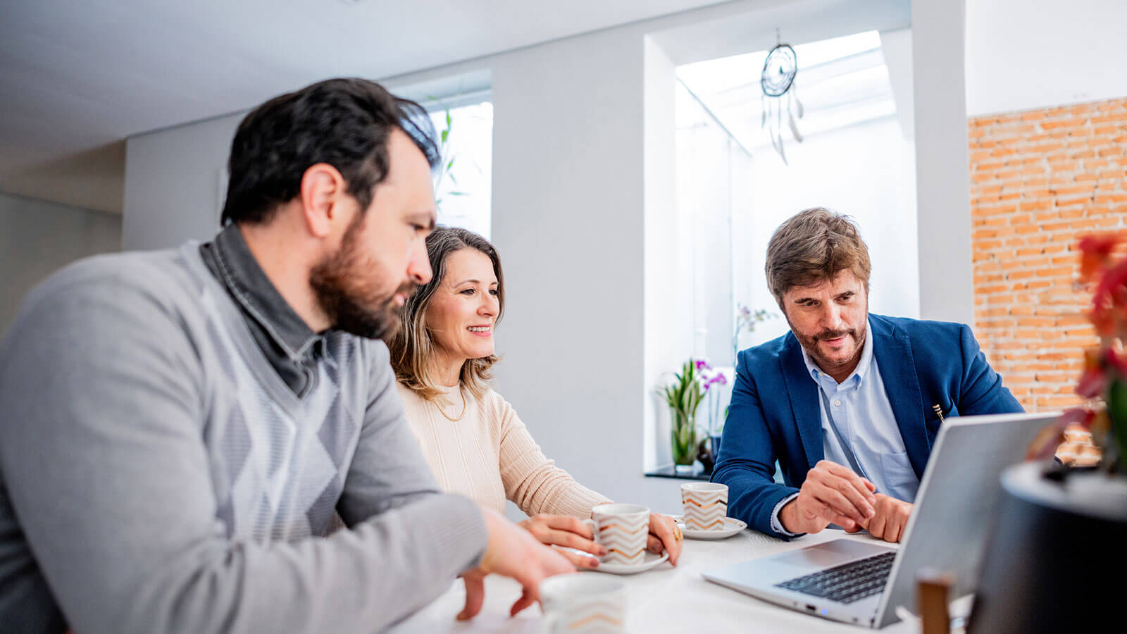 A husband and wife in their late 50s meet with their financial professional to discuss if a Roth IRA makes sense for their financial goals.