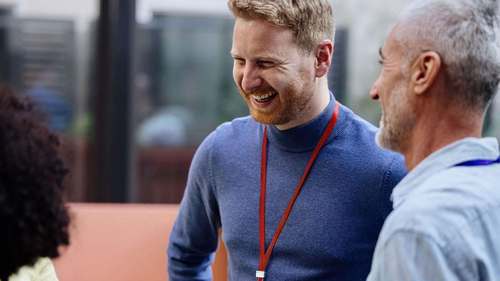A financial professional in his 40s networks with his peers at a professional development conference.