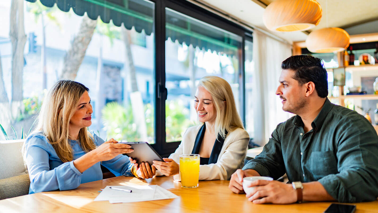 A married couple meets with their financial professional to learn about the differences in permanent life insurance versus term life insurance.