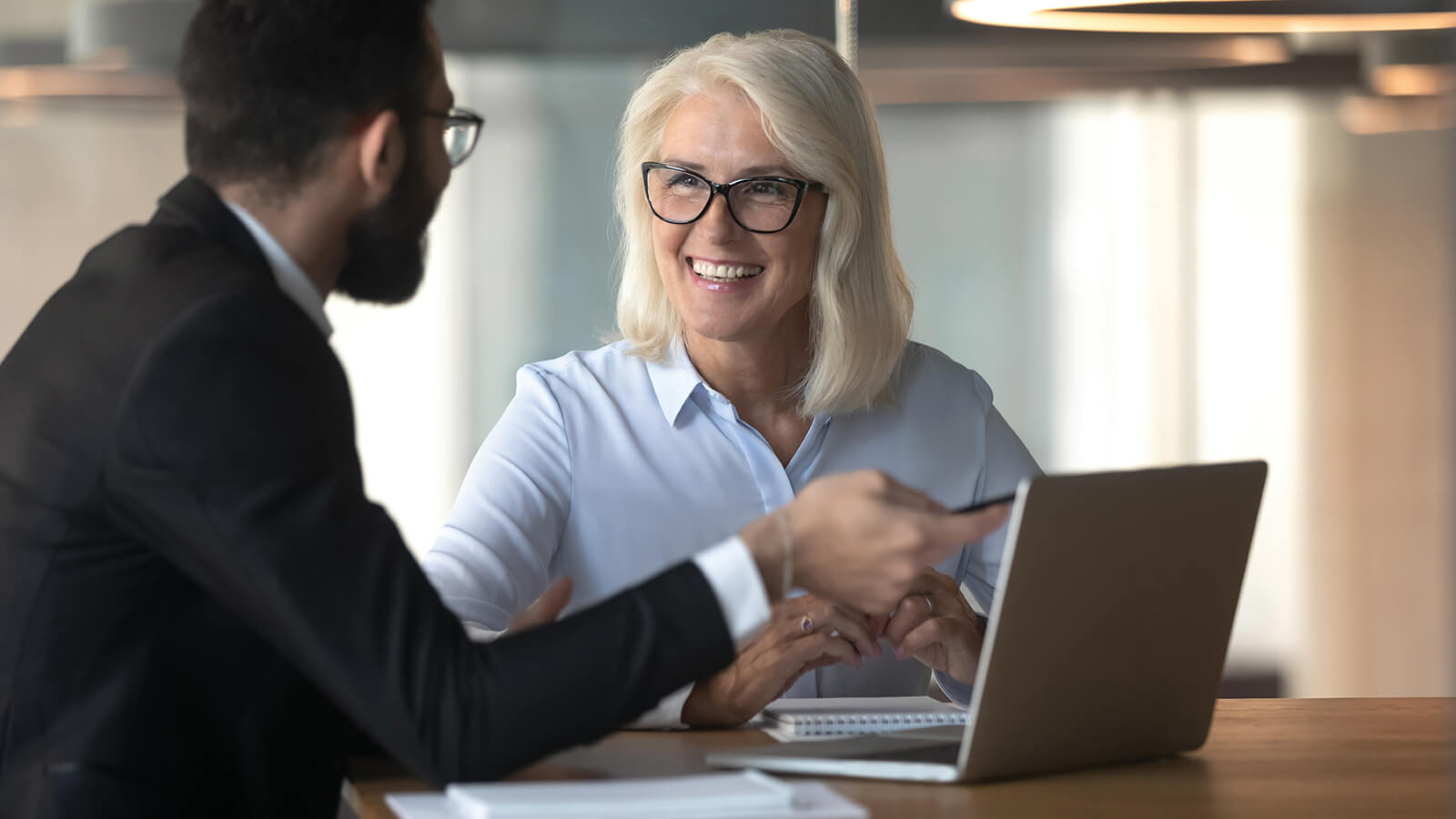 A financial professional sharing information about annuities to a female client.