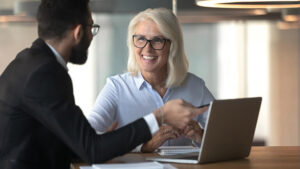 A financial professional sharing information about annuities to a female client.